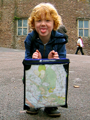 Zac with map, outside the gates of Dunster Castle